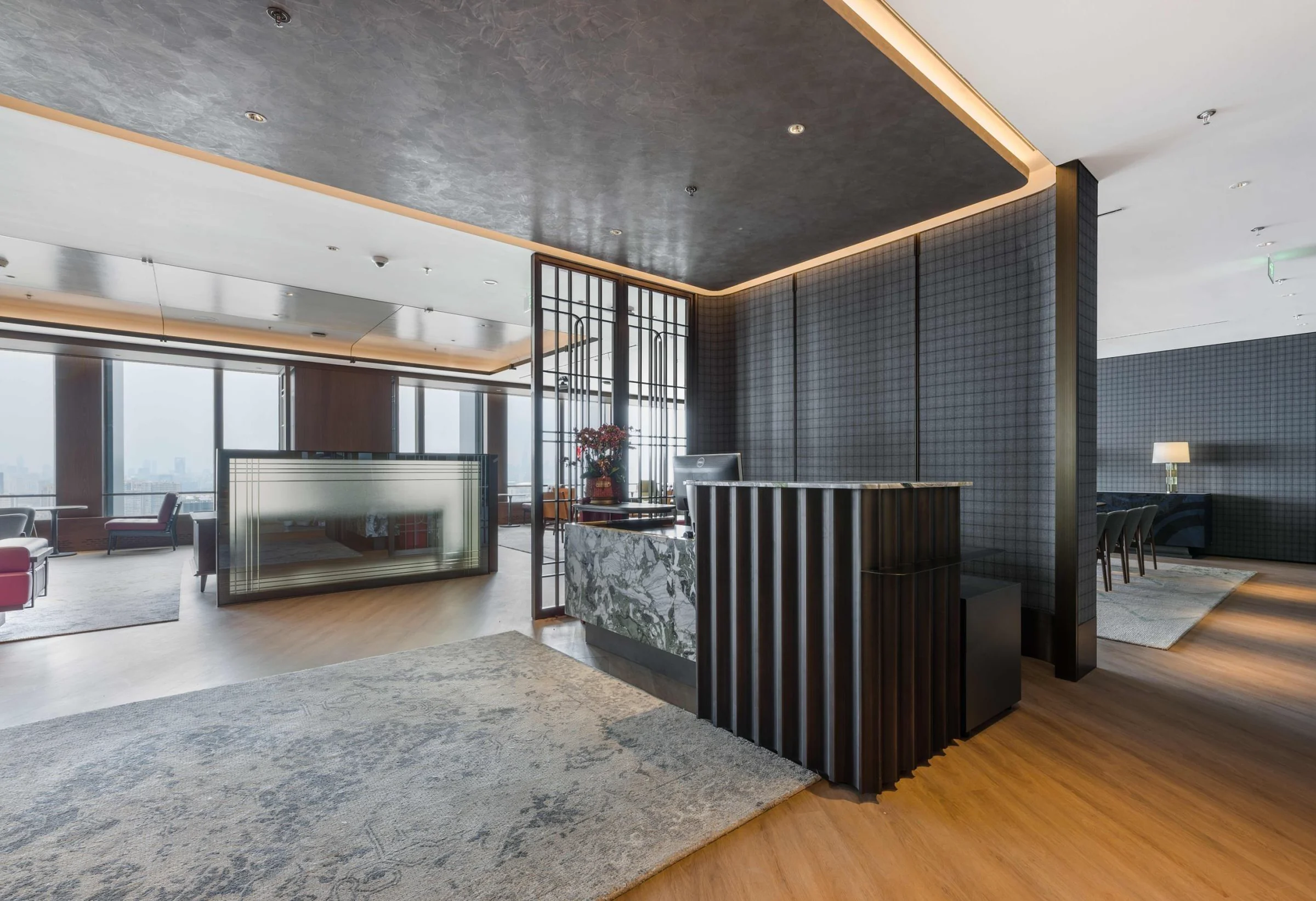 Refined hospitality interior with warm timber and framed city views